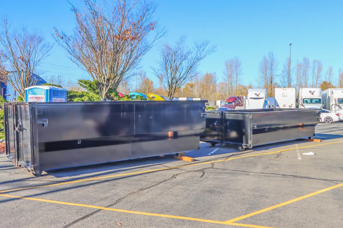 Professional dumpster rental service with roll-off container on residential driveway in Radcliff